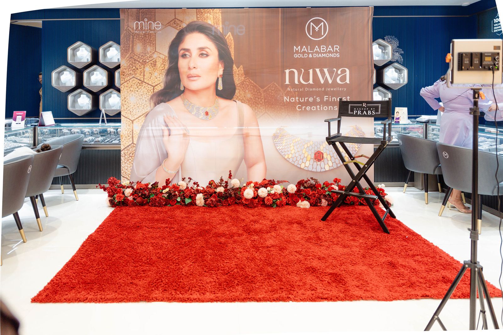 The stage at the Malabar Gold & Diamonds Bridal Masterclass, styled with red florals and a director’s chair